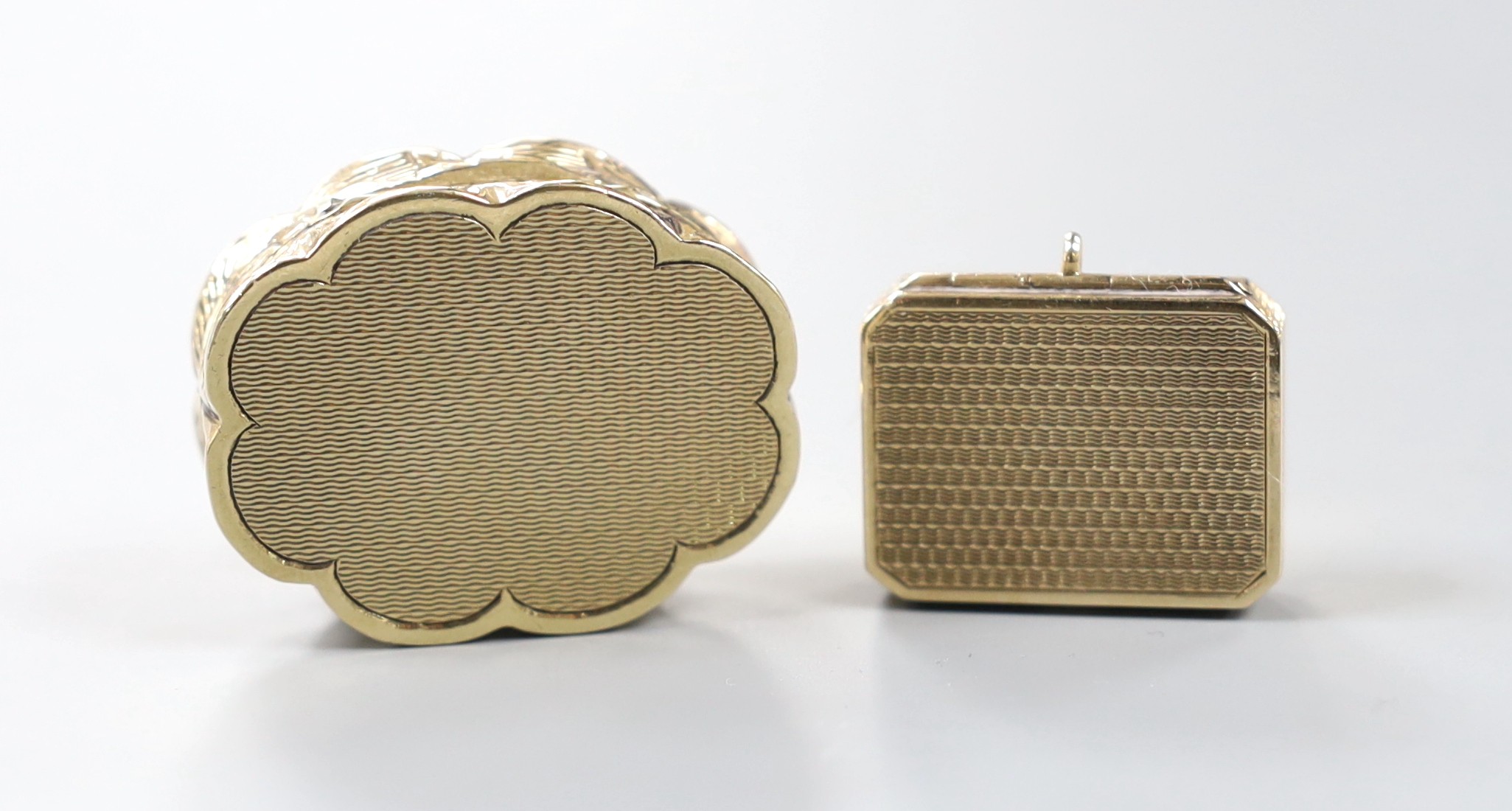 A 1960' 9ct gold shaped oval pill box, 35mm, 22.5 grams and a 9ct gold pill box by Asprey & Co, London, 1925, 25mm, 7.6 grams.